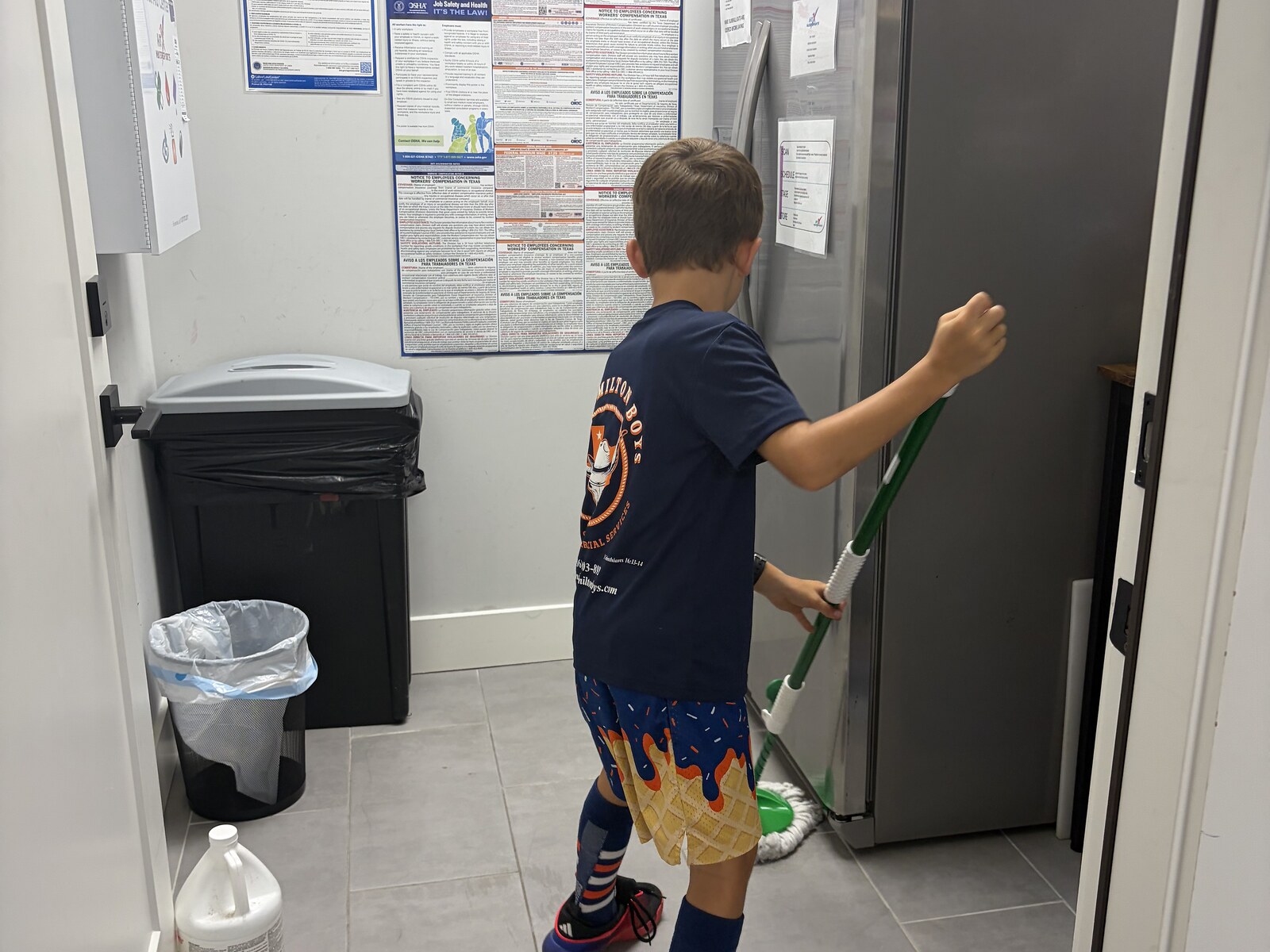 Hamilton Boys crew wiping down commercial refrigerator