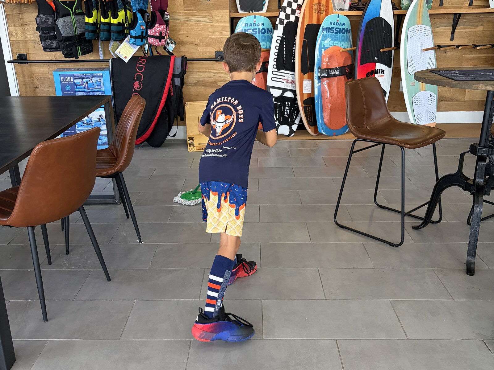 Hamilton Boys crew mopping floor near retail displays