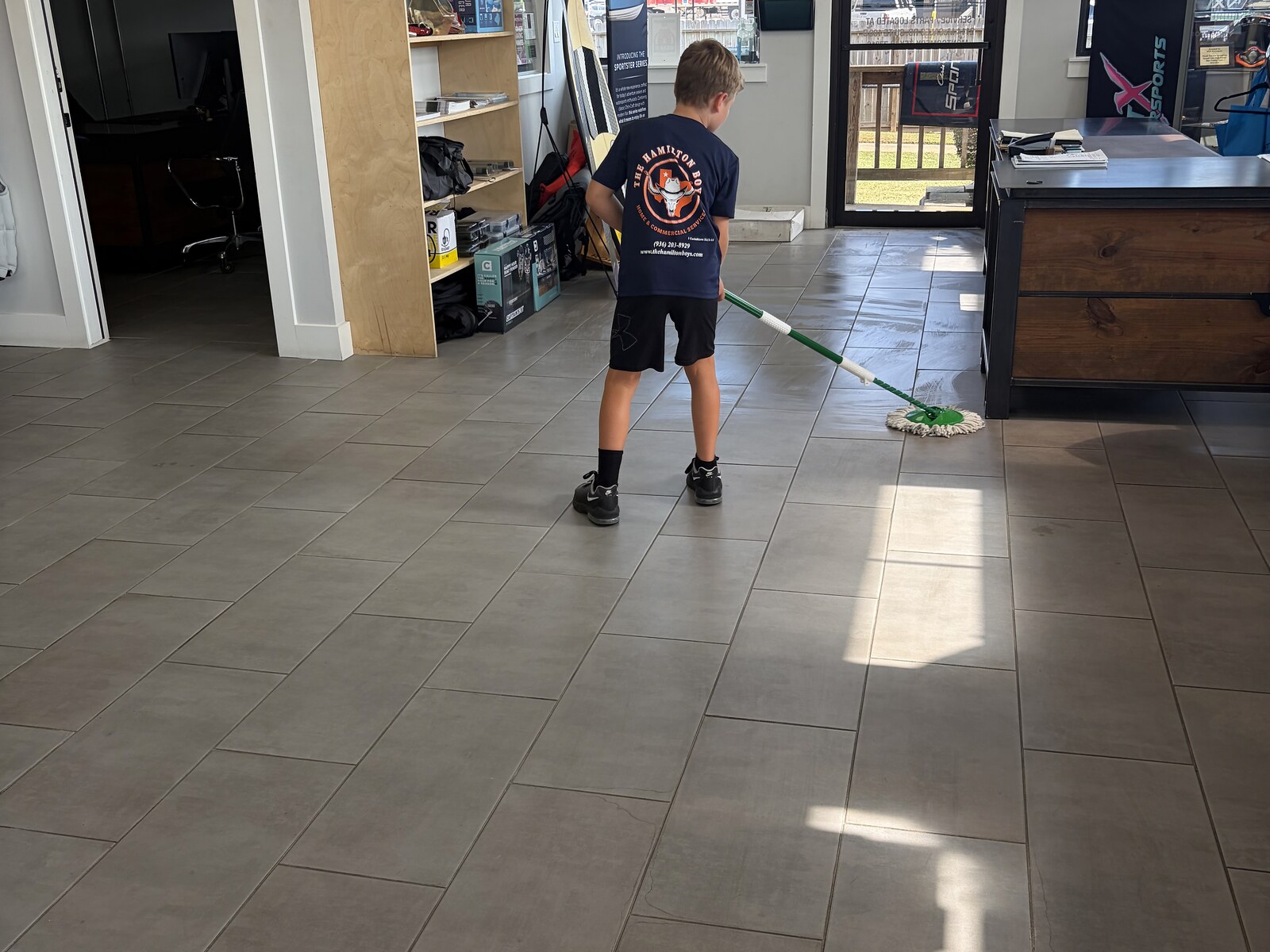 Hamilton Boys crew mopping sunlit commercial floor
