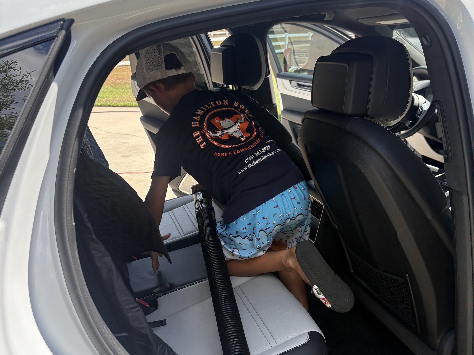 Hamilton Boys crew vacuuming car back seat