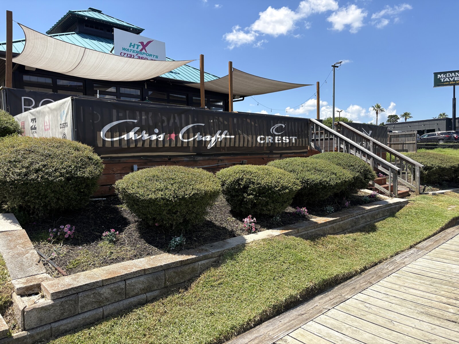 HTX Sales Office after landscaping - trimmed hedge bed by Chris-Craft sign