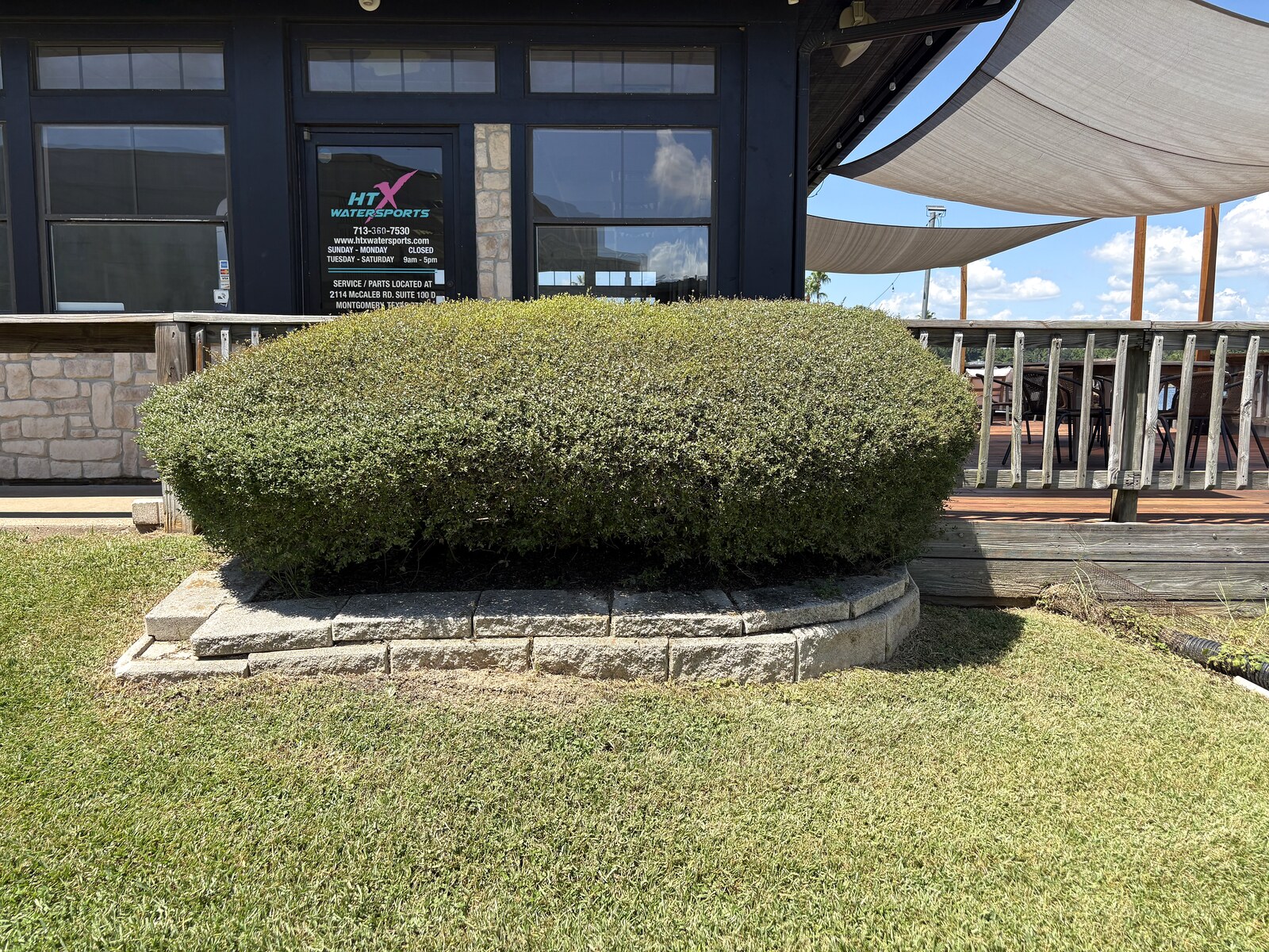 HTX Sales Office after landscaping - manicured shrub at entrance