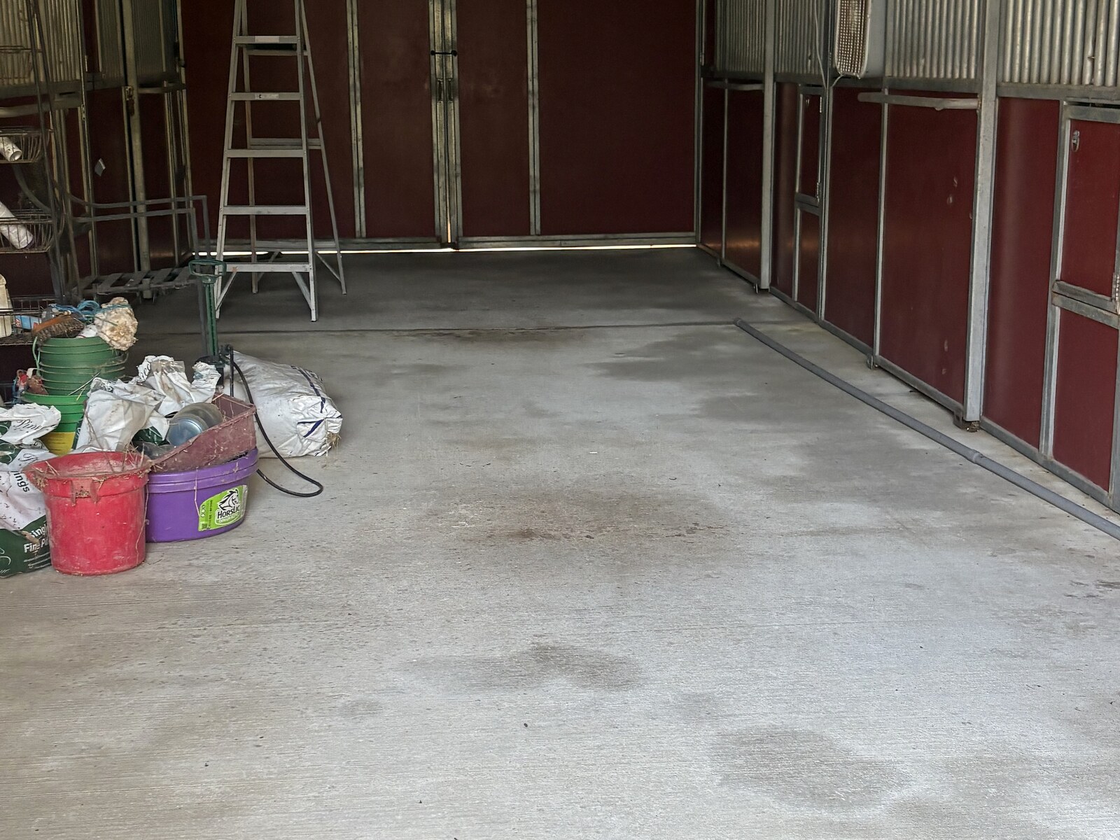 Before pressure washing - stained barn concrete floor